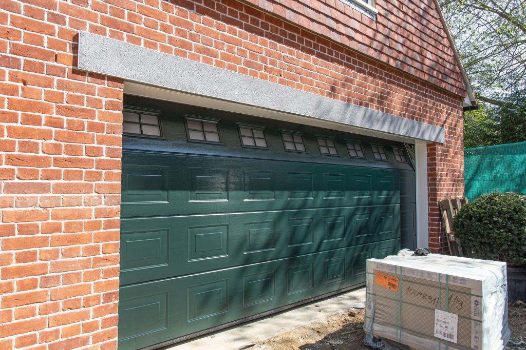 Newly fitted green sectional garage door