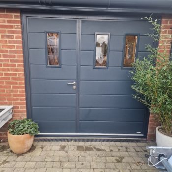 dark grey garage door with front entrance door